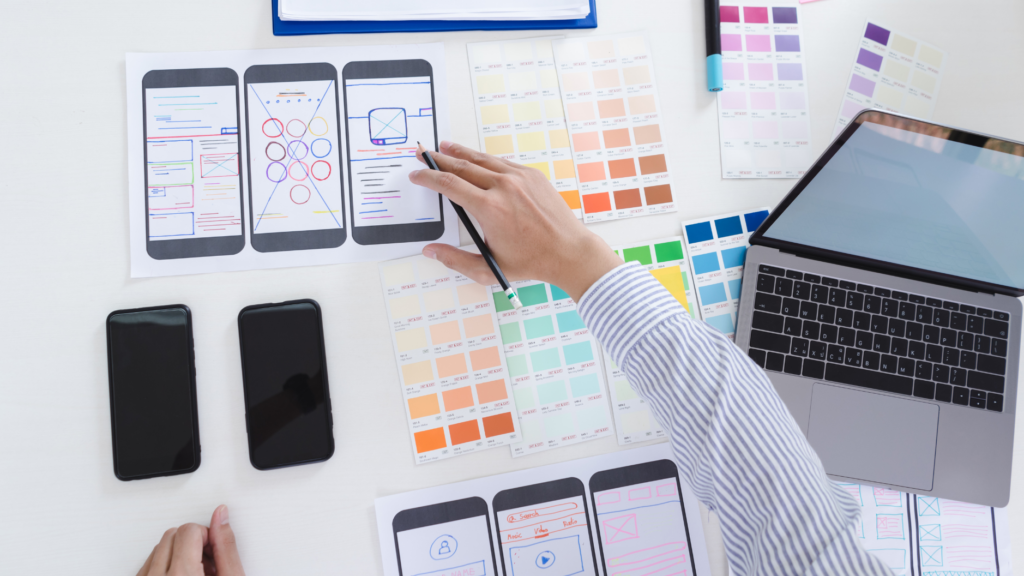 White board with man's hand drawing a user-friendly app choosing colors