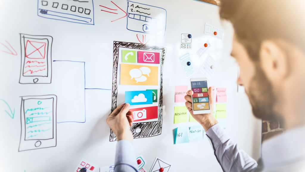 UX UI Dashboard with an engineer holding a mock up of a smartphone