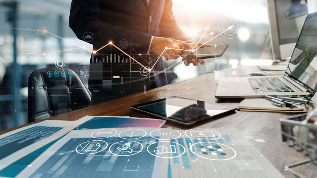 A man holding smartphone on background of office and graphs